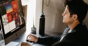 professional graphic designer working on adobe photoshop on an imac in a modern studio setup